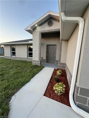 Property entrance featuring a lawn