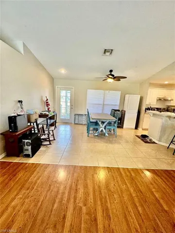 Tiled dining space featuring ceiling fan