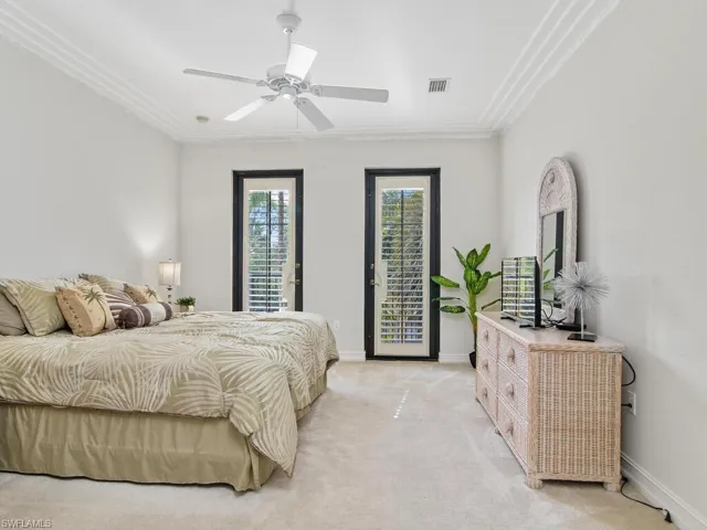 Bedroom featuring access to outside, crown molding, light colored carpet, and a ceiling fan