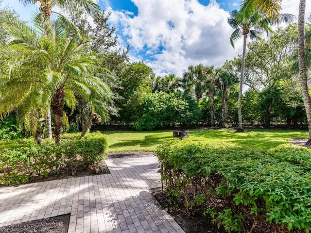 View of property's community featuring a yard and a patio
