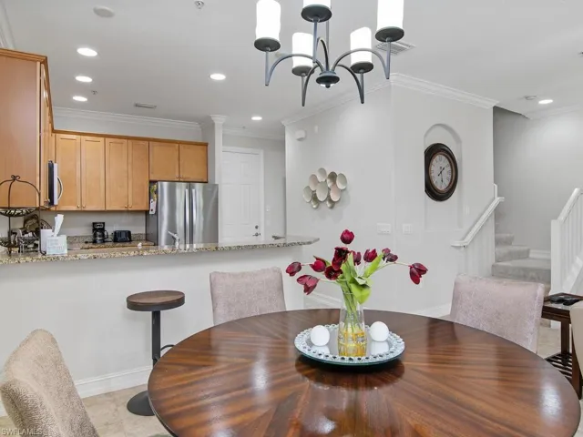 Dining area featuring stairs, recessed lighting, crown molding, and a chandelier