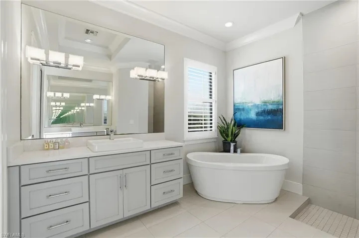 Enjoy your soaking tub or walk in shower with dual vanities in the primary bathroom