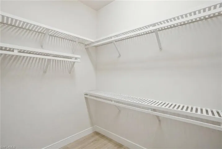 Spacious closets feature wood shelving