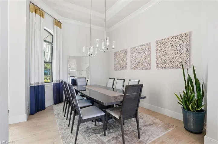 The home features detailed crown molding with multiple tray ceilings