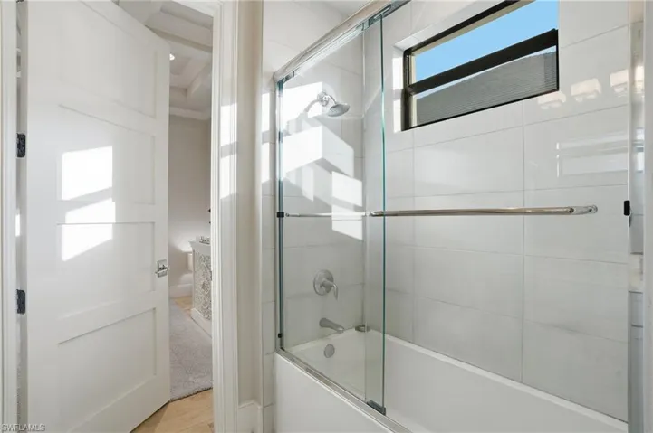The shower/tub combo bathroom offers Jack and Jill access to the den
