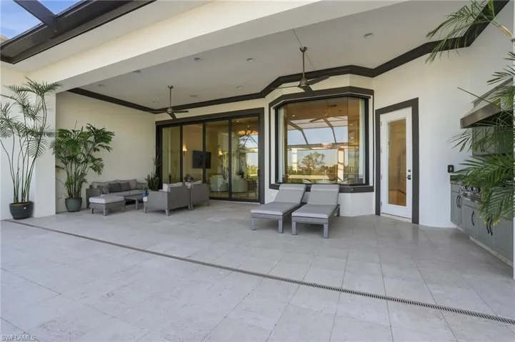 These pocket sliders, covered living area, and summer kitchen create the ideal outdoor living space