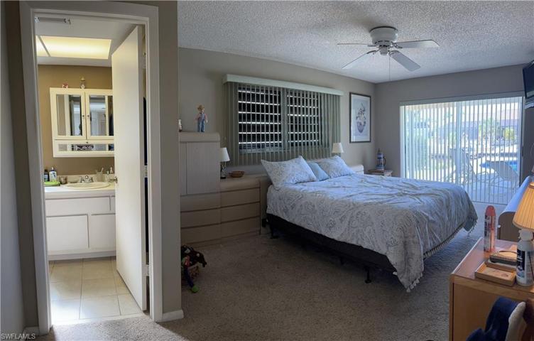 Primary Bedroom overlooks the pool and canal.