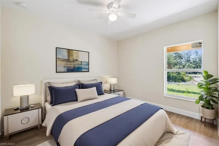Bedroom featuring ceiling fan and wood-type flooring
