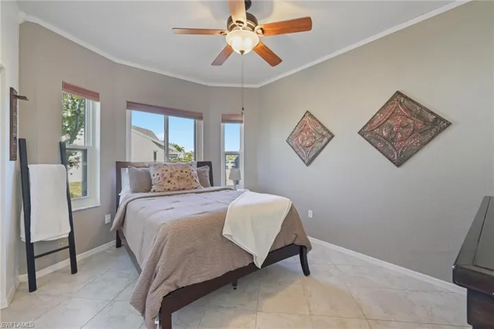 Bedroom featuring ornamental molding and ceiling fan