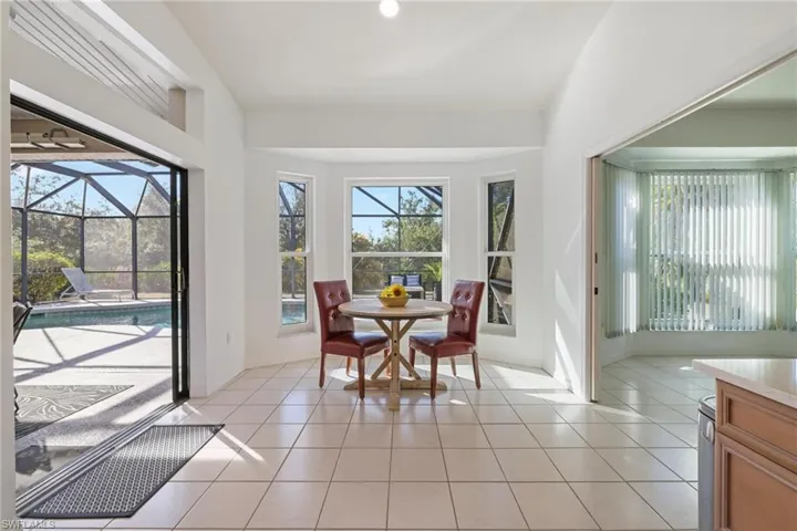 Dining space with a sunroom and light tile patterned floors