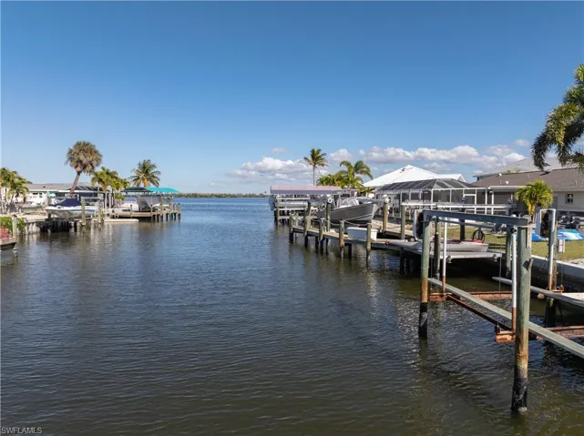 Dock featuring boat lift and a water view