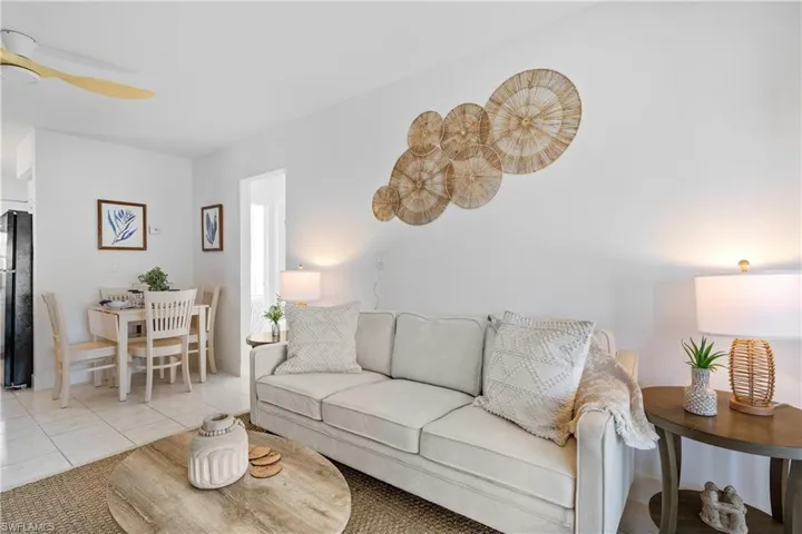 Living area with tile patterned flooring and a ceiling fan