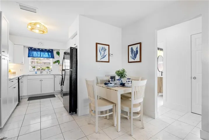 Dining area with light marble finish flooring
