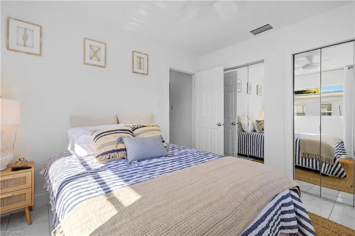 Bedroom featuring two closets and ceiling fan