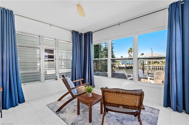 Living area featuring a water view and ceiling fan
