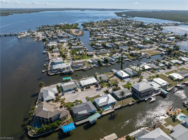 View of property location featuring a nearby body of water and nearby suburban area