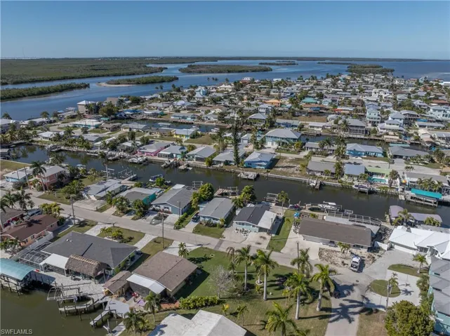 Aerial view of property's location featuring a large body of water and nearby suburban area