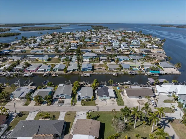 Aerial view of property and surrounding area with nearby suburban area