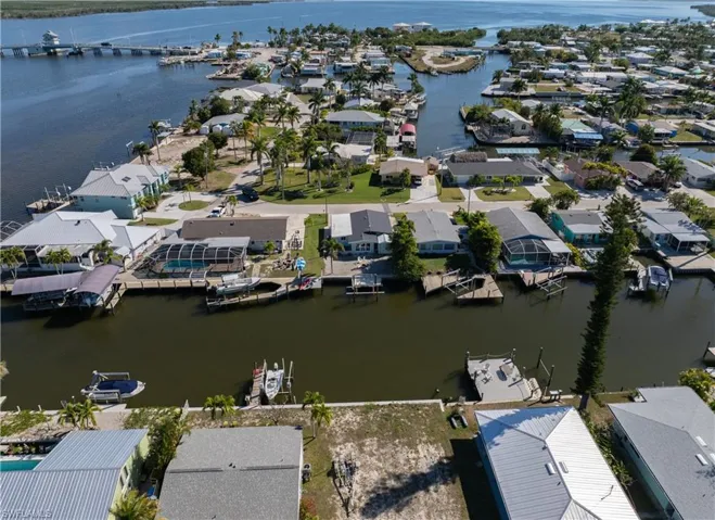 Aerial view of residential area featuring a nearby body of water