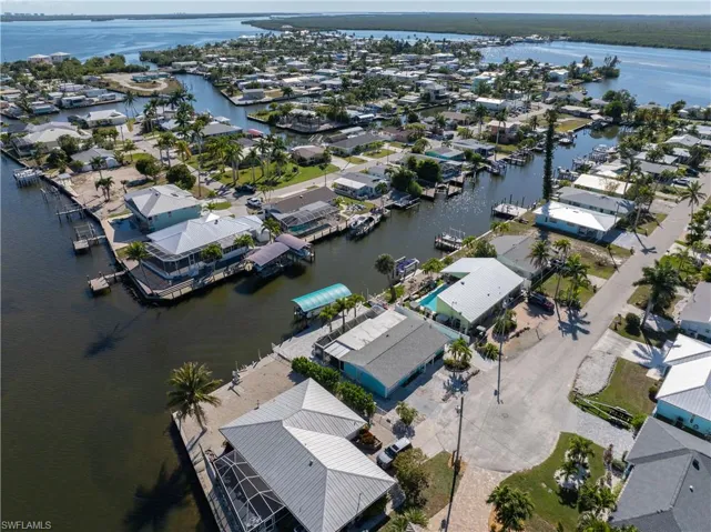 Aerial overview of property's location featuring nearby suburban area and a nearby body of water