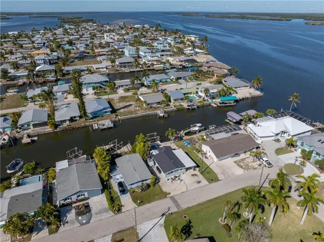 Aerial overview of property's location featuring nearby suburban area and a large body of water