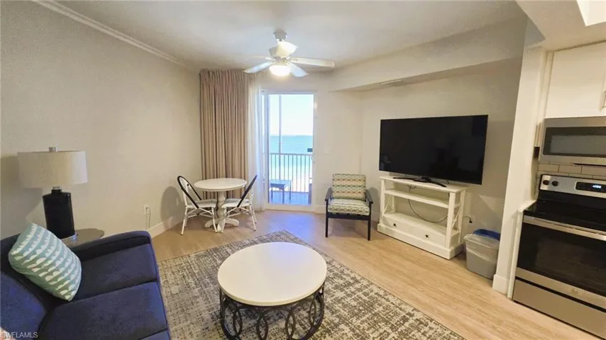 Living room with light wood-style floors and a ceiling fan