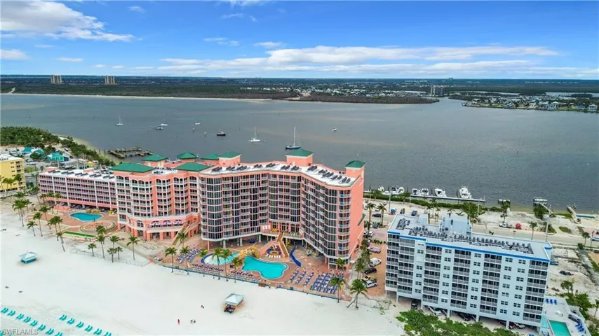 Drone / aerial view of apartment complex and a large body of water