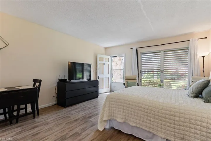 Bedroom featuring light wood-style flooring and a textured ceiling