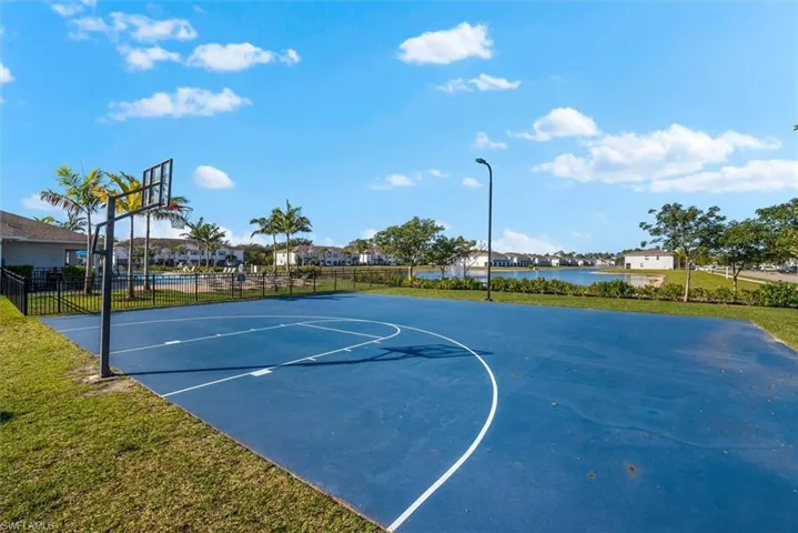 View of sport court with a water view