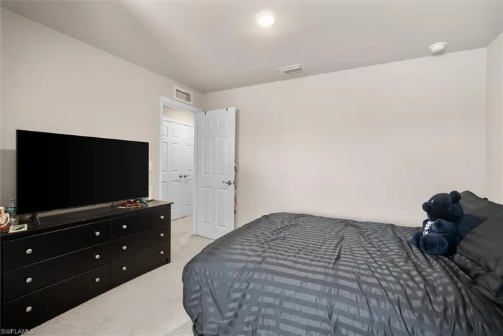 Bedroom with light carpet