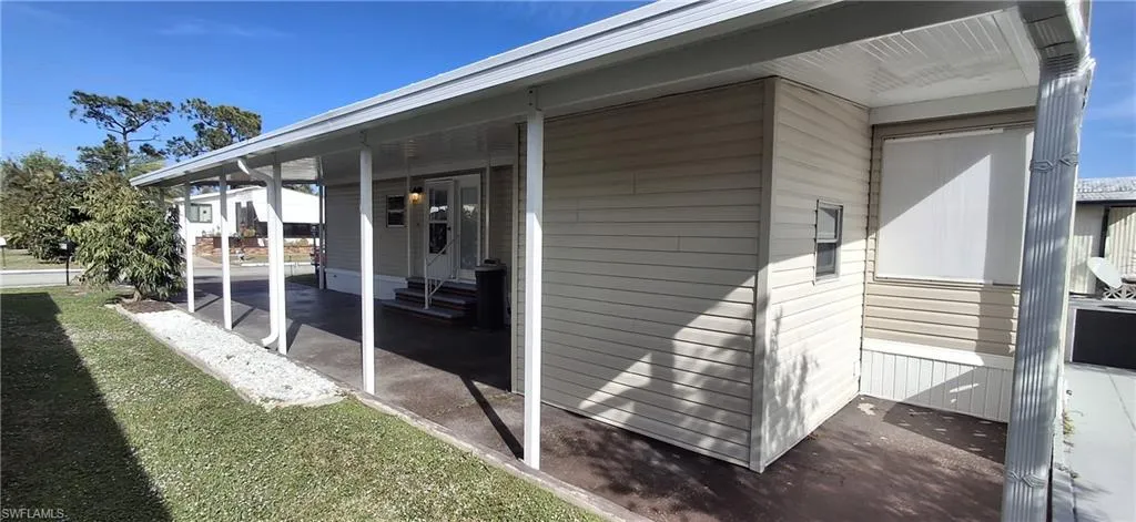 Covered walkway to rear yard and gutters with downspouts