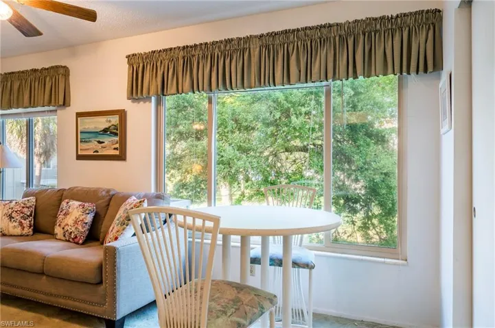 Living room featuring a textured ceiling and ceiling fan