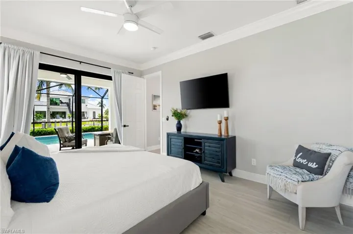 Master bedroom with lots of natural light looking out to the pool
