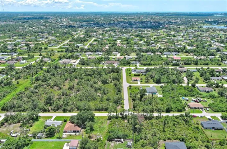 Aerial view of property's location featuring nearby suburban area
