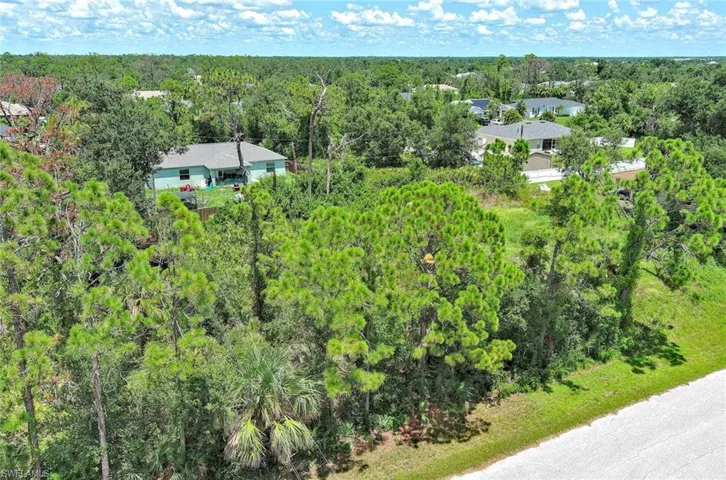 View of subject property featuring a heavily wooded area