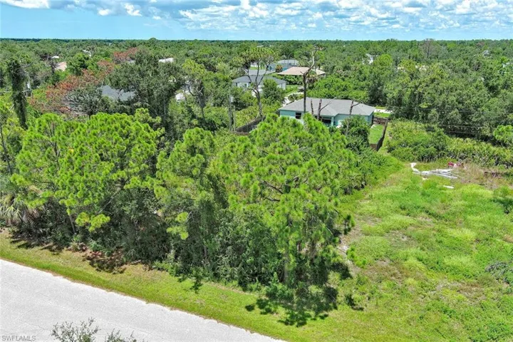 View from above of property featuring a heavily wooded area