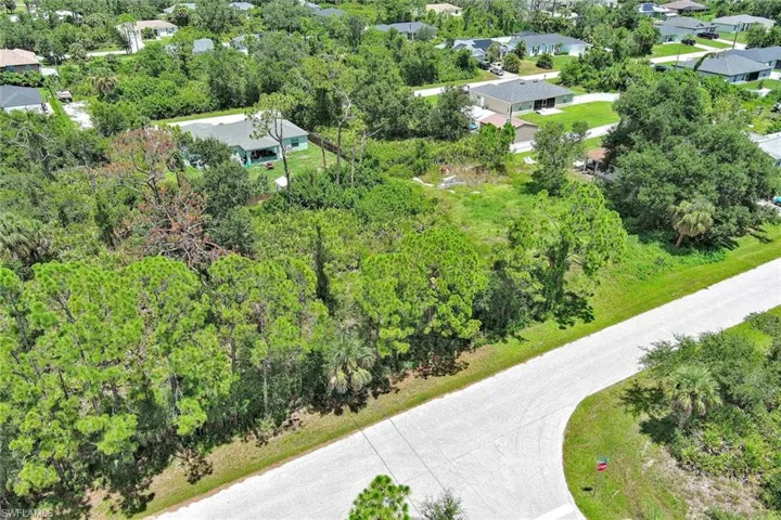 Aerial perspective of suburban area featuring a tree filled landscape