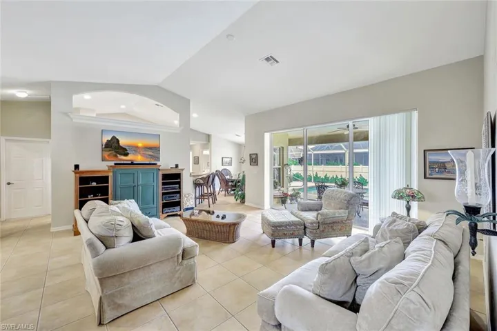 Living room featuring lofted ceiling and light tile patterned floors