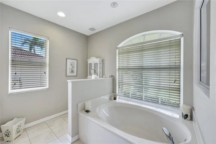 Bathroom featuring tile patterned flooring and a bathing tub