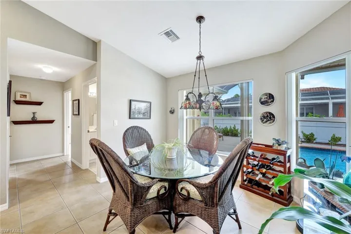 Tiled dining room featuring a notable chandelier