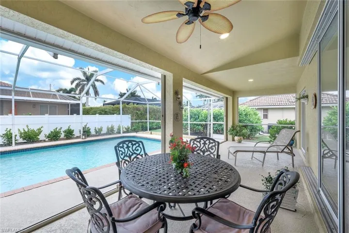 Sunroom with ceiling fan, plenty of natural light, and lofted ceiling