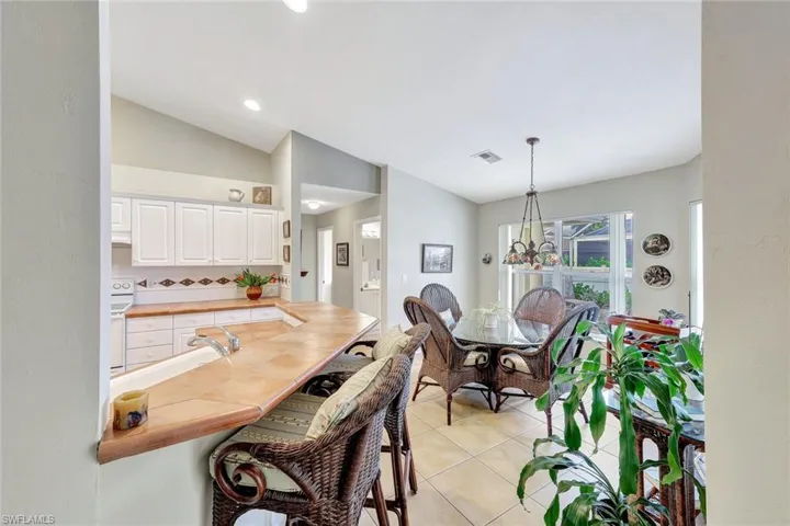 Dining area featuring lofted ceiling and light tile patterned flooring