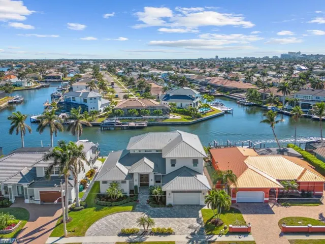 Birds eye view of property with a water view