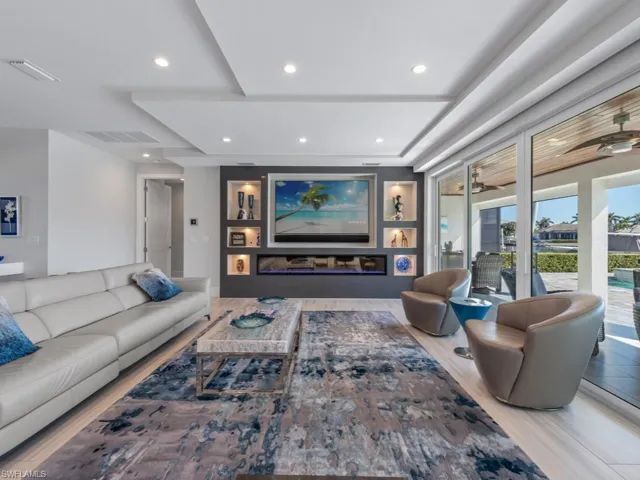 Living room with hardwood / wood-style flooring and ceiling fan