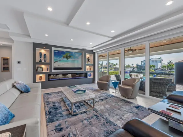 Living room with wood-type flooring, french doors, and ceiling fan