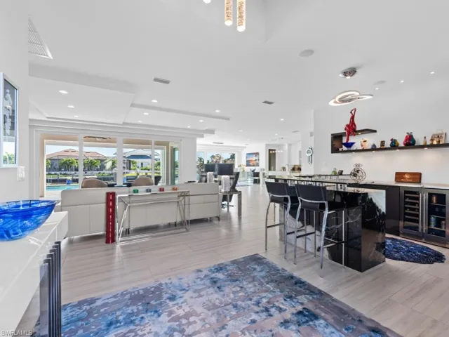 Bar with white cabinetry and wine cooler