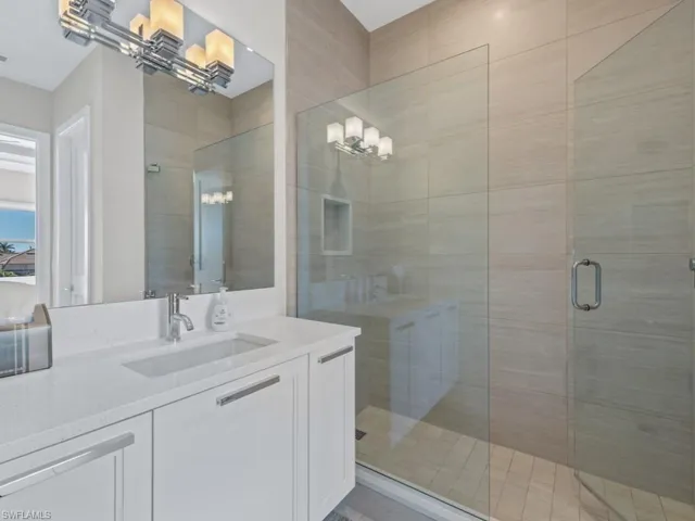 Bathroom featuring vanity and a shower with shower door