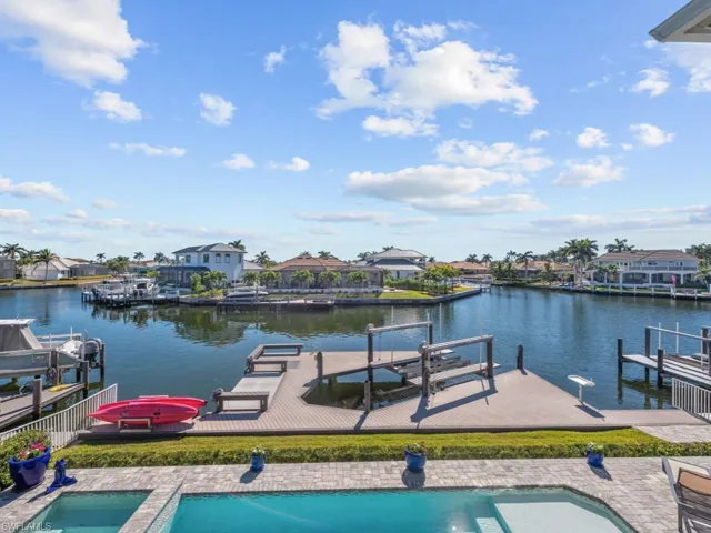 View of dock with a patio area and a water view