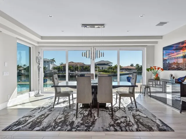 Dining space featuring light hardwood / wood-style floors and a water view