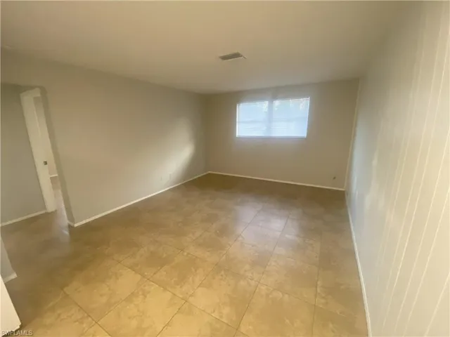 Unfurnished room featuring baseboards
